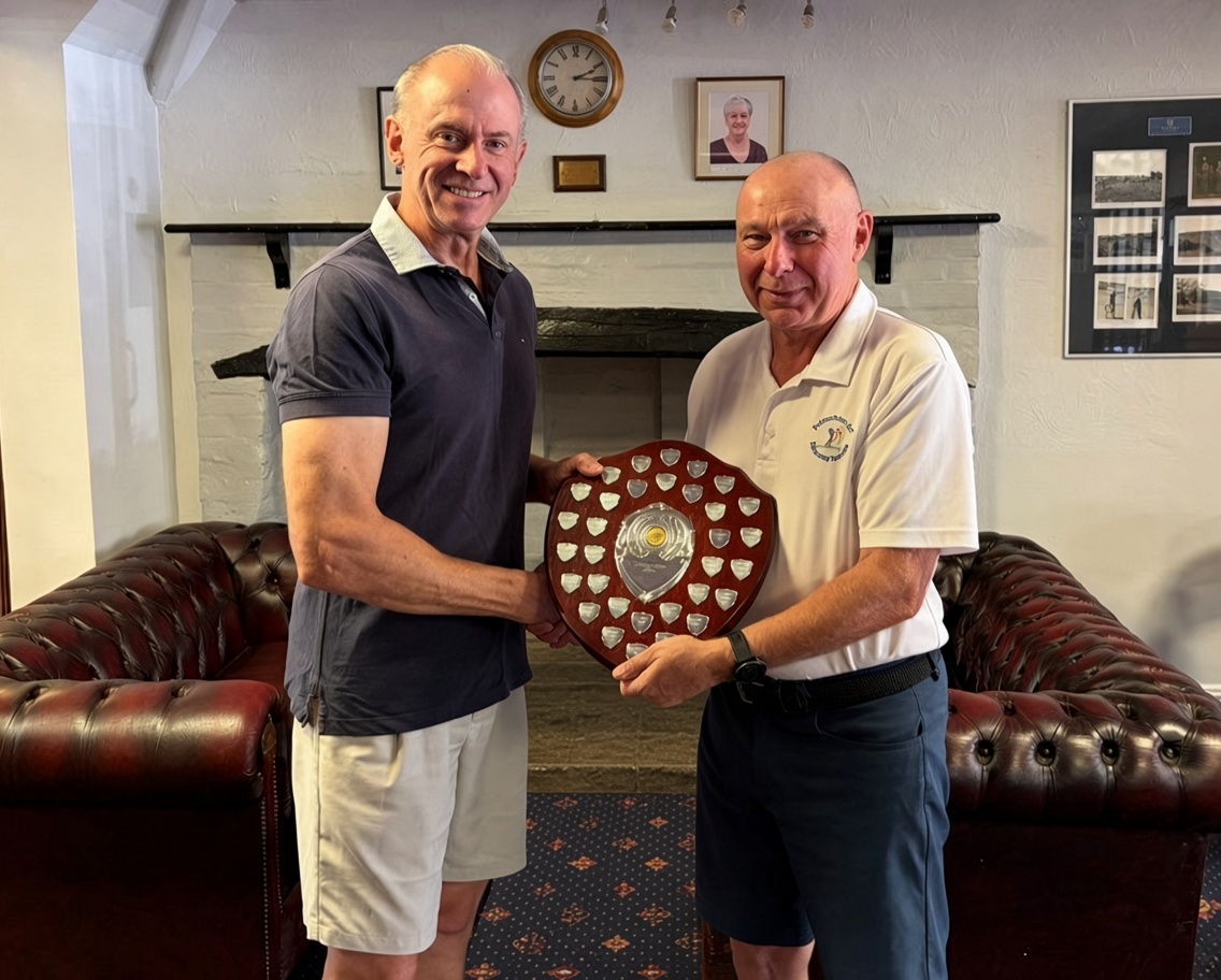 Colin Reardon receiving the Swindle Shield from John Fitz